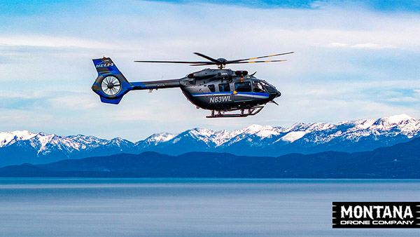 Heli 1 Flying Over Flathead Lake Snowy Mission Mountains Background 